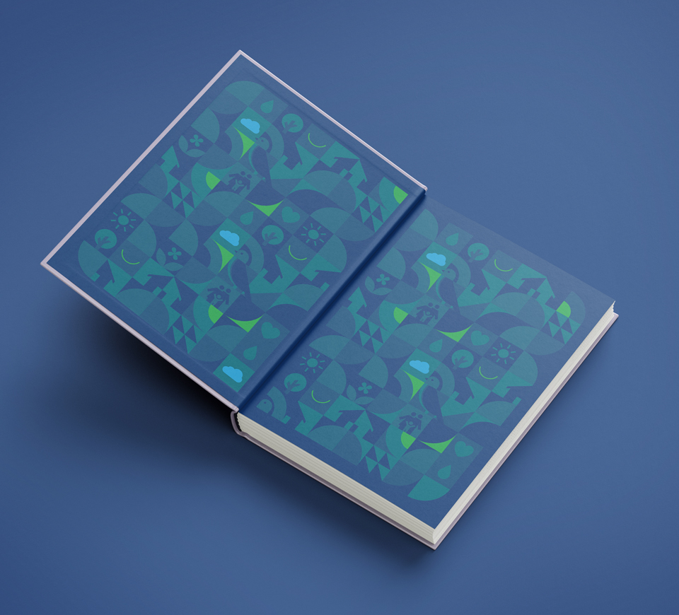 Mayan Homes brand diary inside cover with abstract geometric patterns of houses, trees, clouds, hearts, and nature symbols in blue and green colors